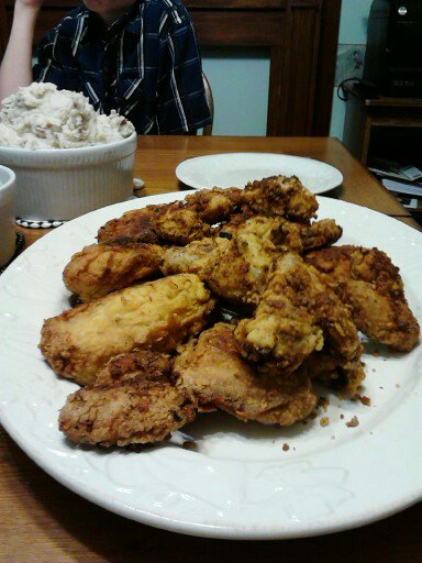 Buttermilk Fried Chicken with Mounds of Smashed Potatoes and a hungry child in the background.